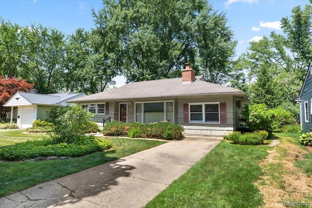 15588 Kirkshire Ave, Beverly Hills, MI 48025 - ranch-style home featuring a chimney, a front yard, driveway, a garage, and roof with shingles