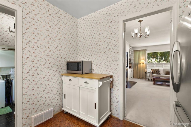 15588 Kirkshire Ave, Beverly Hills, MI 48025 - kitchen with appliances with stainless steel finishes, wood counters, wallpapered walls, a chandelier, and white cabinets