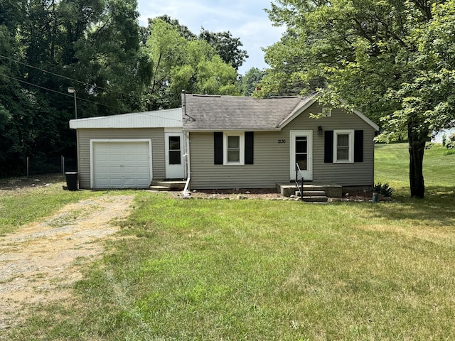 1230 Golden Ave, Battle Creek, MI 49014 - ranch-style home featuring driveway, roof with shingles, a front yard, and an attached garage