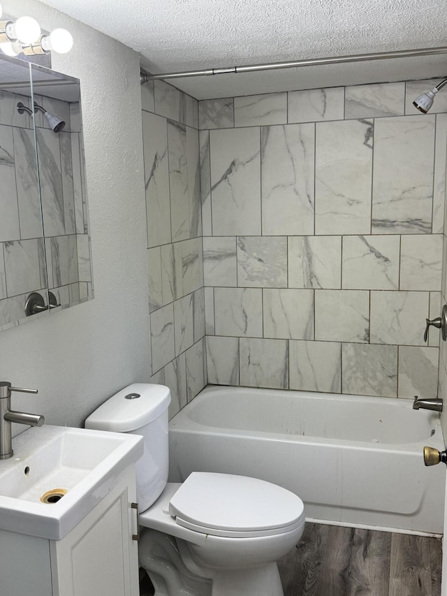 1230 Golden Ave, Battle Creek, MI 49014 - full bath with a textured ceiling, vanity,  shower combination, a textured wall, and wood finished floors