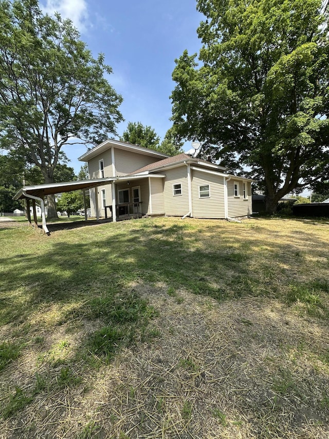 811 W Lincoln Ave, Ionia, MI 48846 - back of property featuring a yard and a carport