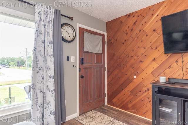 205 Shotka St, Westland, MI 48186 - foyer entrance with healthy amount of natural light, wood finished floors, wooden walls, and a textured ceiling