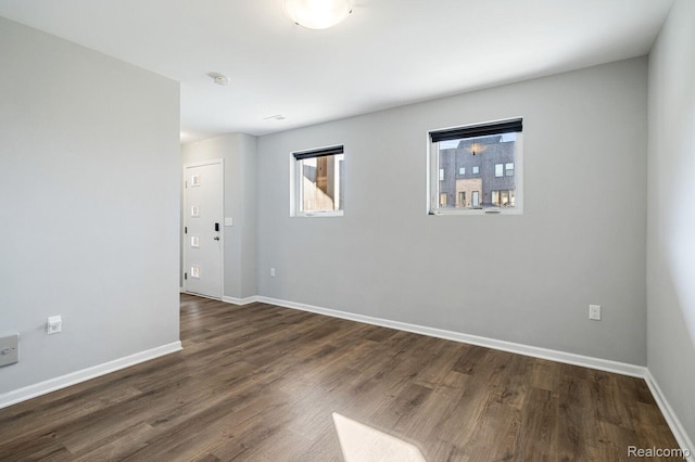 1087 Hampton Cir Unit 55, Detroit, MI 48207 - spare room with dark wood-style flooring