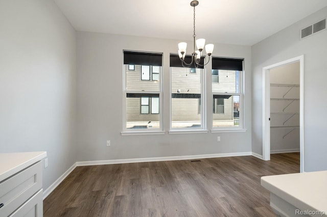 1087 Hampton Cir Unit 55, Detroit, MI 48207 - unfurnished dining area featuring a chandelier and dark wood-type flooring