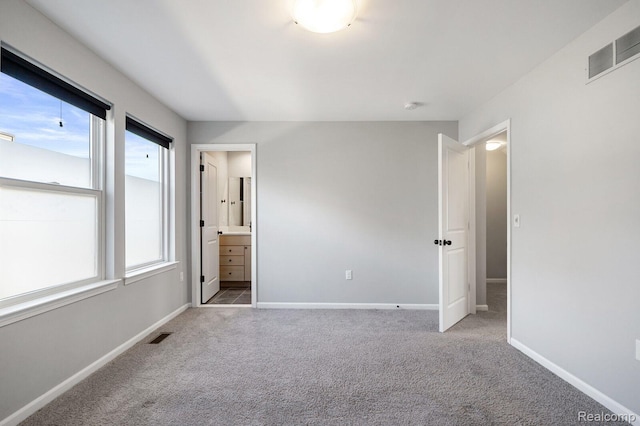 1087 Hampton Cir Unit 55, Detroit, MI 48207 - unfurnished bedroom with carpet floors and connected bathroom