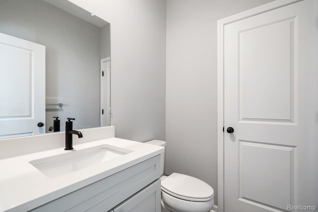 1087 Hampton Cir Unit 55, Detroit, MI 48207 - half bathroom featuring vanity and toilet