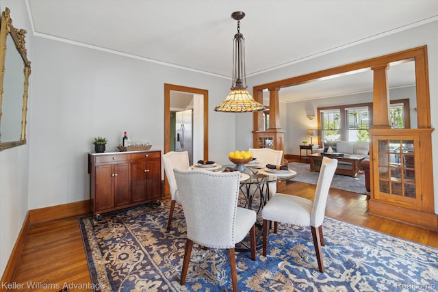 402 E 7th St, Royal Oak, MI 48067 - dining space with dark wood-style floors, ornamental molding, and decorative columns