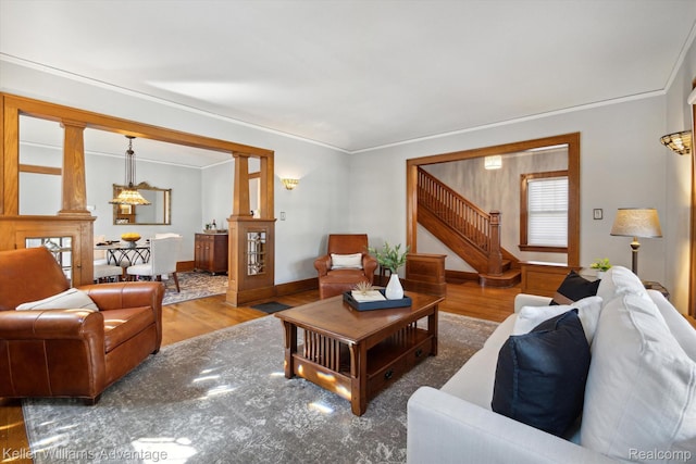 402 E 7th St, Royal Oak, MI 48067 - living room with wood finished floors, a chandelier, crown molding, and stairway