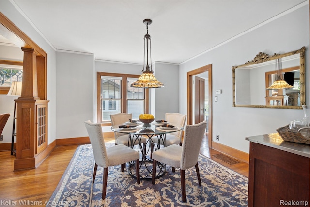 402 E 7th St, Royal Oak, MI 48067 - dining room with plenty of natural light, light wood finished floors, ornamental molding, and ornate columns