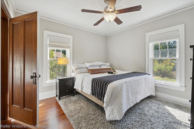 402 E 7th St, Royal Oak, MI 48067 - bedroom with multiple windows, ornamental molding, wood finished floors, and a ceiling fan