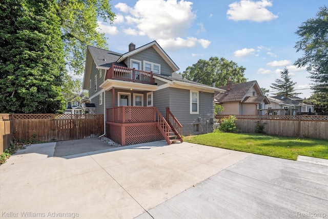 402 E 7th St, Royal Oak, MI 48067 - view of front facade with a balcony, a chimney, a fenced backyard, and roof with shingles