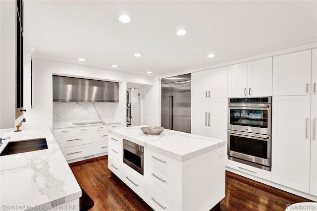 4768 Wendrick Dr, West Bloomfield, MI 48323 - kitchen with built in appliances, dark wood finished floors, light stone counters, and recessed lighting