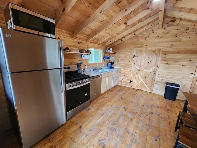 2599 N Pine Ave, White Cloud, MI 49349 - kitchen with stainless steel appliances, light wood finished floors, wooden walls, open shelves, and wooden ceiling