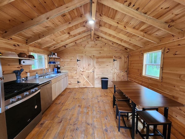 2599 N Pine Ave, White Cloud, MI 49349 - kitchen with appliances with stainless steel finishes, open shelves, light wood-style flooring, wooden ceiling, and wood walls