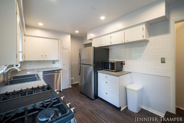 4001 Hillsdale Ave NE, Grand Rapids, MI 49525 - kitchen with appliances with stainless steel finishes, light countertops, backsplash, dark wood finished floors, and recessed lighting