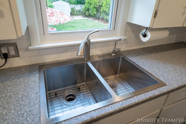 4001 Hillsdale Ave NE, Grand Rapids, MI 49525 - kitchen view of decorative backsplash, white cabinets, and dark countertops