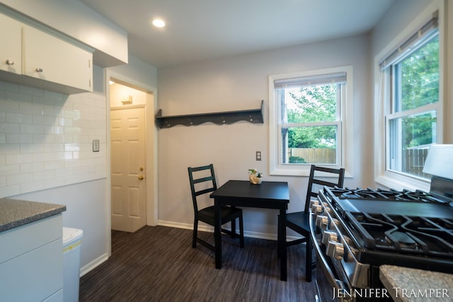 4001 Hillsdale Ave NE, Grand Rapids, MI 49525 - kitchen featuring gas stove, dark wood-style flooring, decorative backsplash, white cabinets, and healthy amount of natural light