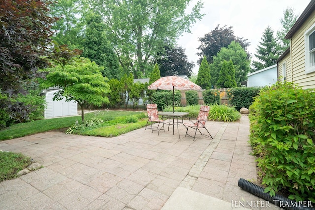 4001 Hillsdale Ave NE, Grand Rapids, MI 49525 - fenced backyard with a patio, a storage unit, and outdoor dining area