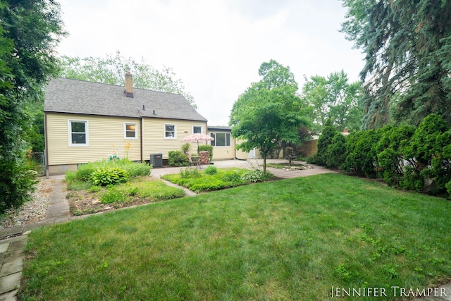 4001 Hillsdale Ave NE, Grand Rapids, MI 49525 - back of house featuring a patio area, a chimney, and a yard