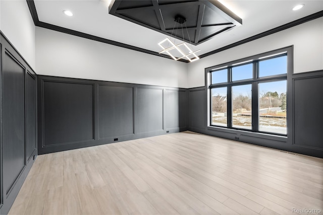 2555 Fairway Ct, Rochester, MI 48306 - spare room with a decorative wall, a chandelier, crown molding, wainscoting, and light wood-type flooring