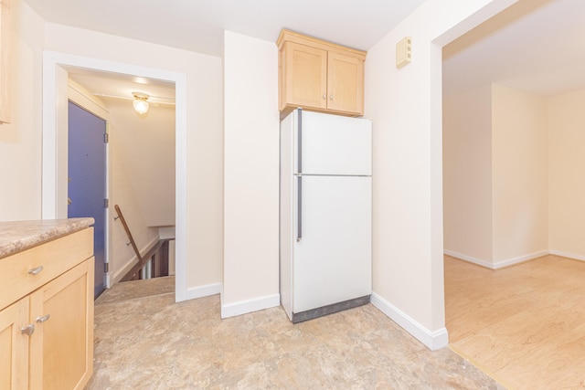 501 W Mosley St, Ann Arbor, MI 48103 - kitchen featuring freestanding refrigerator, light brown cabinetry, and light countertops