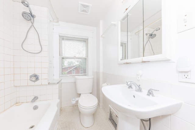 501 W Mosley St, Ann Arbor, MI 48103 - bathroom featuring tile walls, a tub, tile patterned floors, a shower, and wainscoting
