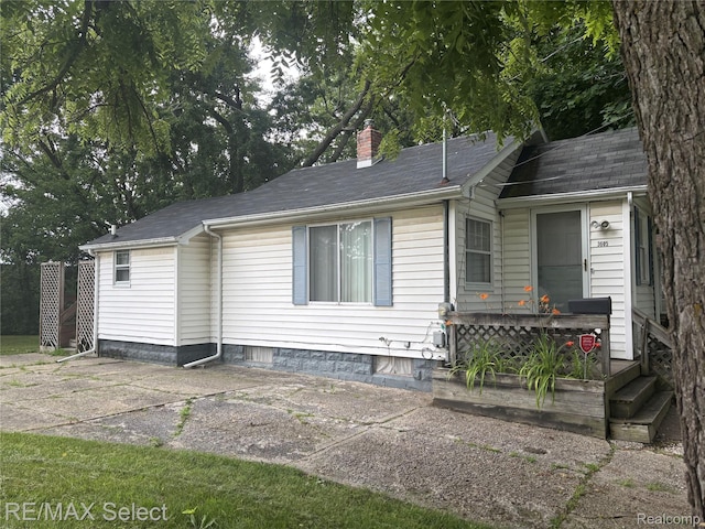 3605 Hogarth Ave, Flint, MI 48532 - view of property exterior with a chimney and a shingled roof