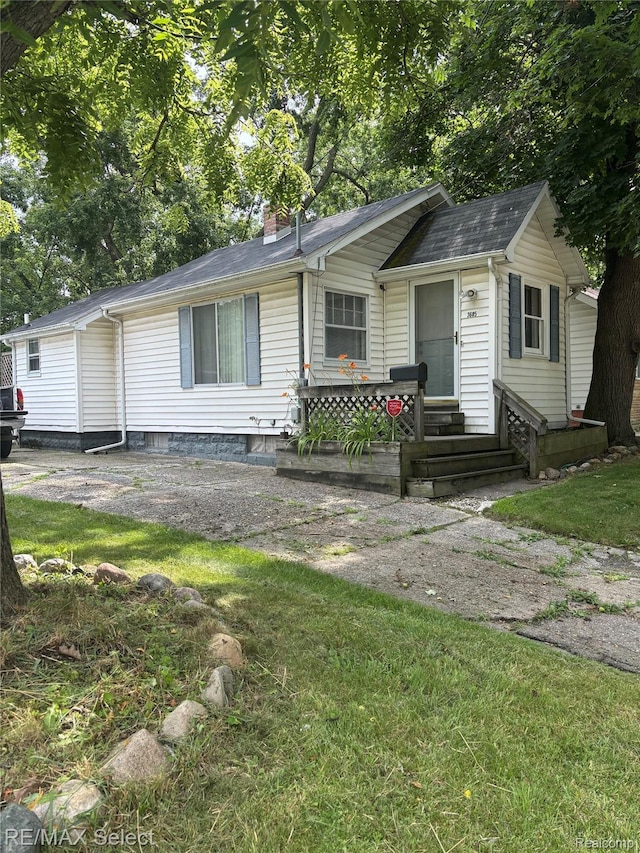 3605 Hogarth Ave, Flint, MI 48532 - ranch-style home featuring a chimney, entry steps, and a front lawn