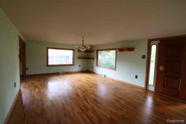 6048 N Lapeer Rd, Fostoria, MI 48435 - foyer entrance with a chandelier and wood finished floors