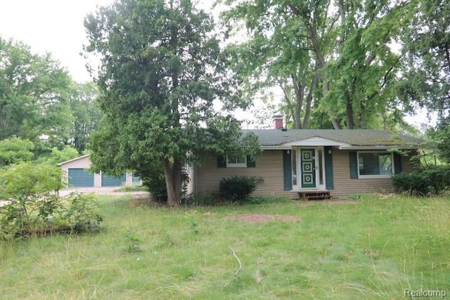 6048 N Lapeer Rd, Fostoria, MI 48435 - view of front of home featuring a chimney and a garage
