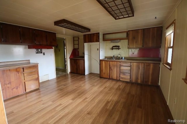 6048 N Lapeer Rd, Fostoria, MI 48435 - kitchen with light wood-style flooring and backsplash