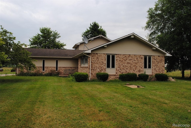 4785 Mayer Rd, China, MI 48054 - back of house with brick siding and a lawn