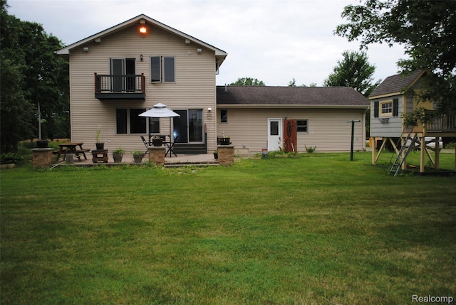 4785 Mayer Rd, China, MI 48054 - back of house featuring a balcony, a yard, and a patio area