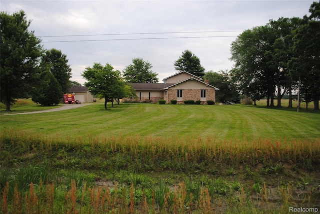4785 Mayer Rd, China, MI 48054 - view of front of house featuring a front lawn, driveway, and brick siding