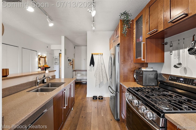 432 S Washington Ave Unit 1402, Royal Oak, MI 48067 - kitchen with stainless steel appliances, brown cabinets, wood-type flooring, and glass insert cabinets
