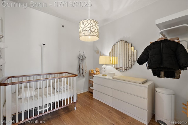432 S Washington Ave Unit 1402, Royal Oak, MI 48067 - bedroom featuring wood finished floors and a nursery area