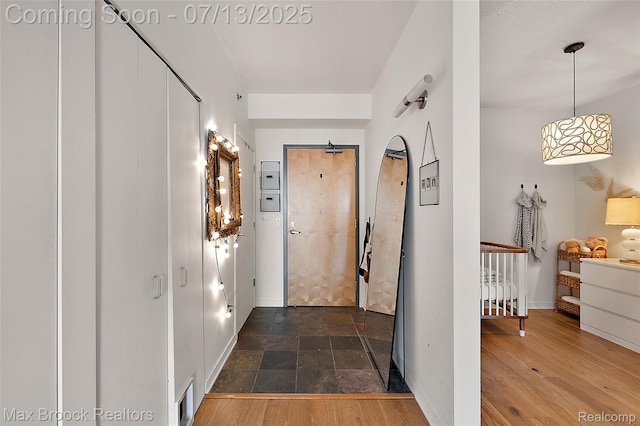 432 S Washington Ave Unit 1402, Royal Oak, MI 48067 - hall with baseboards and stone finish floors