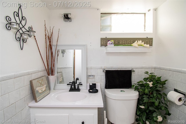 20310 Burt Rd, Detroit, MI 48219 - bathroom featuring tile walls, vanity, and wainscoting