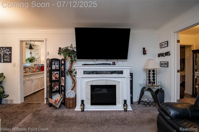 20310 Burt Rd, Detroit, MI 48219 - living area featuring carpet flooring and a glass covered fireplace