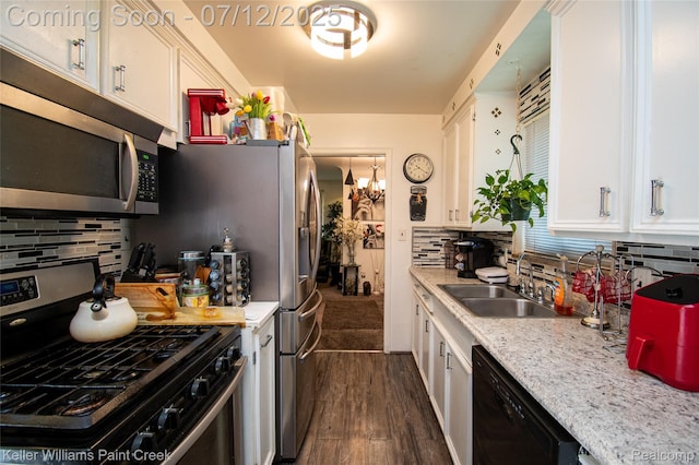 20310 Burt Rd, Detroit, MI 48219 - kitchen with stainless steel appliances, white cabinetry, tasteful backsplash, and dark wood-style floors