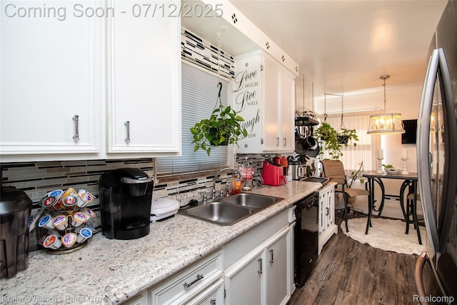 20310 Burt Rd, Detroit, MI 48219 - kitchen with white cabinetry, decorative backsplash, dark wood-style floors, black dishwasher, and freestanding refrigerator