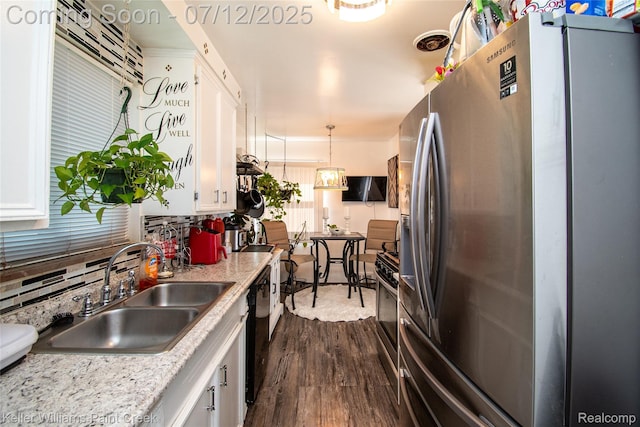 20310 Burt Rd, Detroit, MI 48219 - kitchen featuring stainless steel appliances, white cabinets, dark wood finished floors, and light countertops