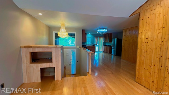 45903 Dutton Dr, Shelby Twp, MI 48044 - corridor with a chandelier and light wood-type flooring