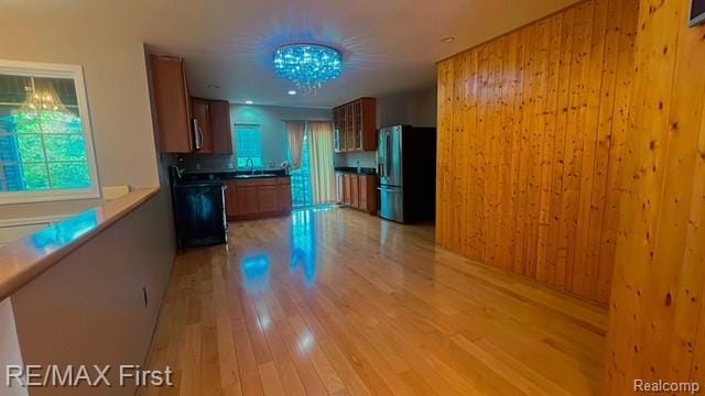45903 Dutton Dr, Shelby Twp, MI 48044 - kitchen featuring refrigerator with ice dispenser, range, light wood finished floors, stainless steel microwave, and brown cabinets