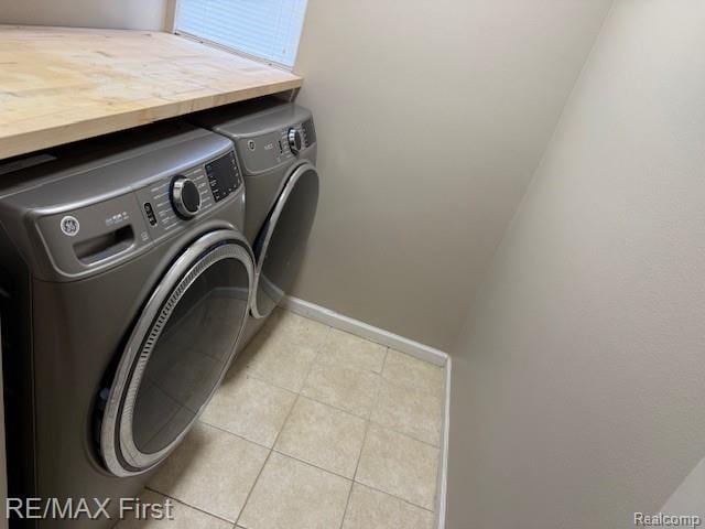45903 Dutton Dr, Shelby Twp, MI 48044 - laundry room featuring separate washer and dryer and light tile patterned floors