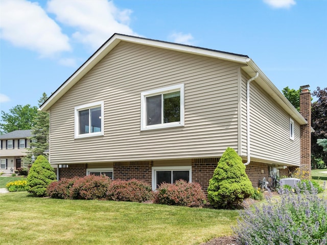 890 Darwin Place Ct, Rochester Hills, MI 48307 - view of property exterior featuring brick siding and a lawn