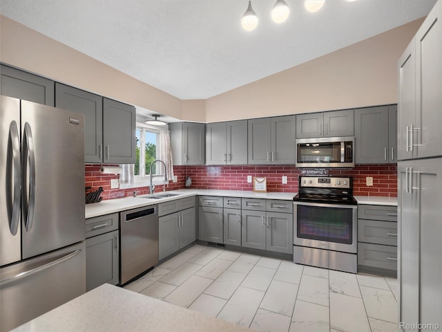 890 Darwin Place Ct, Rochester Hills, MI 48307 - kitchen featuring appliances with stainless steel finishes, gray cabinetry, light marble finish floors, light countertops, and decorative backsplash