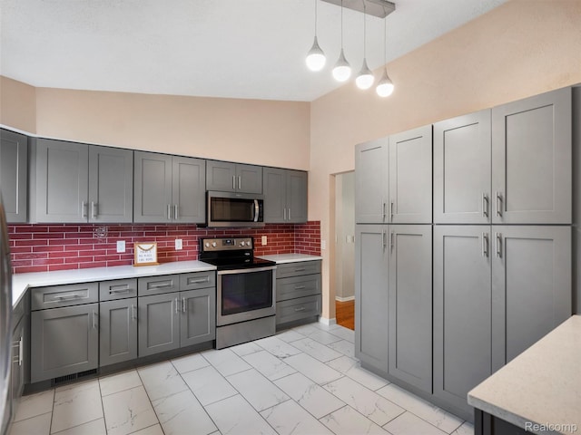 890 Darwin Place Ct, Rochester Hills, MI 48307 - kitchen featuring stainless steel appliances, gray cabinets, light marble finish floors, and high vaulted ceiling