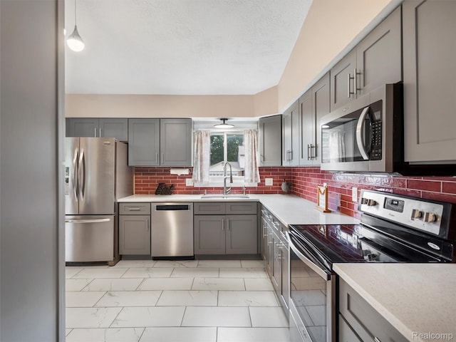 890 Darwin Place Ct, Rochester Hills, MI 48307 - kitchen with stainless steel appliances, gray cabinets, light countertops, light marble finish flooring, and a textured ceiling