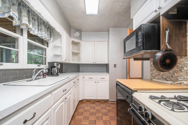 2736 Cascade Rd SE, Grand Rapids, MI 49506 - kitchen with black appliances, white cabinetry, light countertops, and decorative backsplash